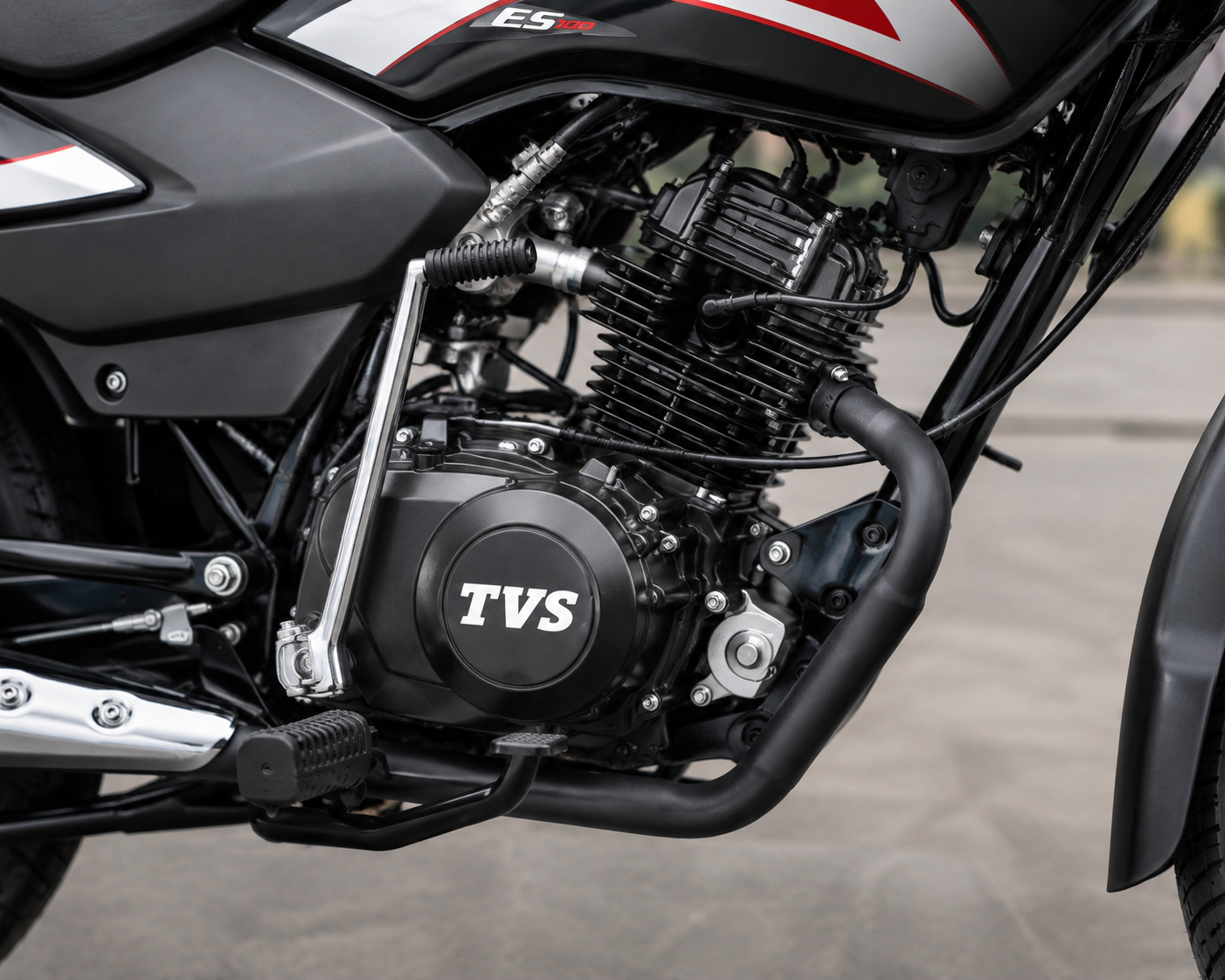 TVS Sport front three-quarter view showing headlamp and body graphics