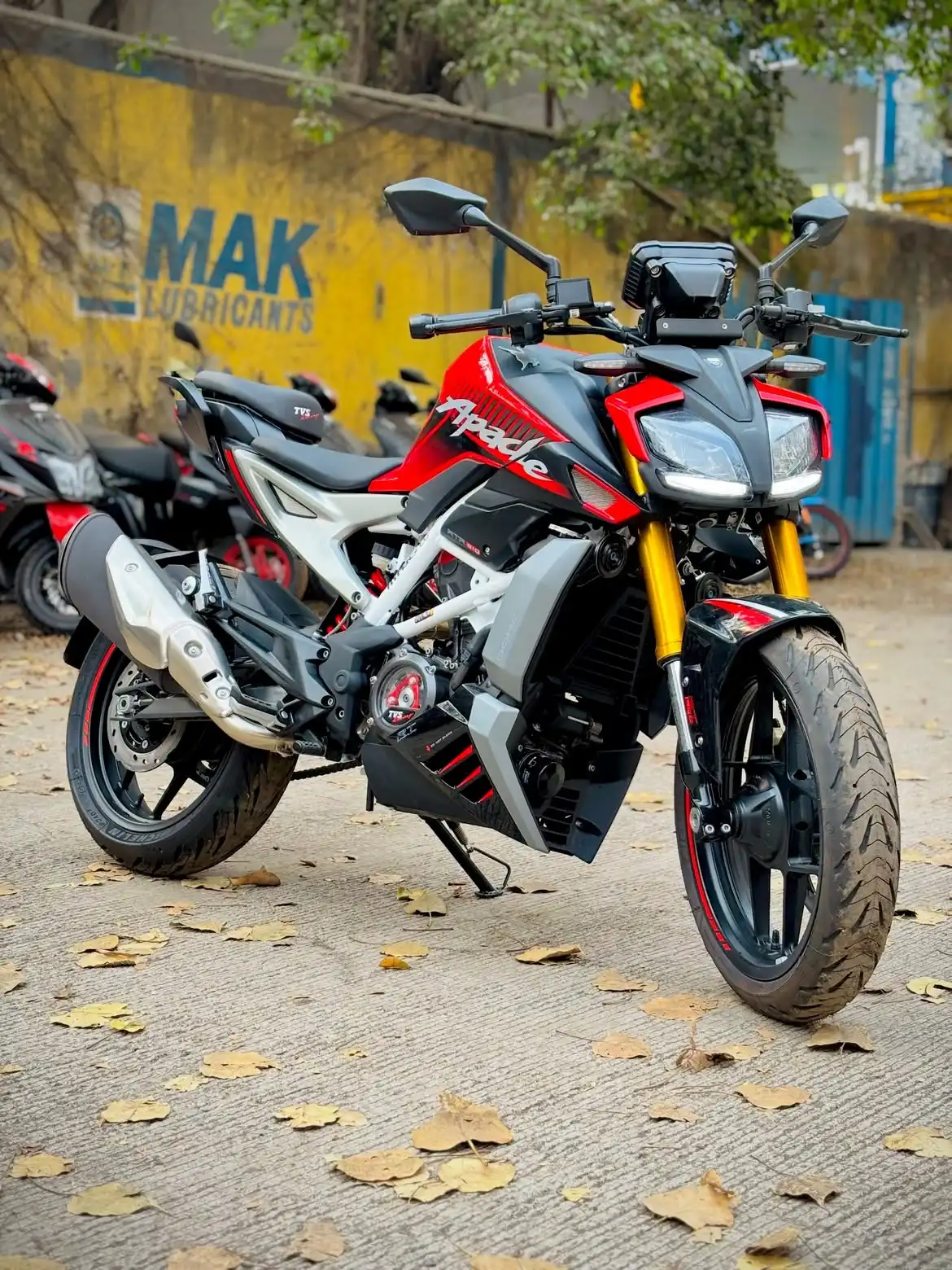 2026 TVS Apache RTR 310 in Fiery Red parked on a city road, front three-quarter view