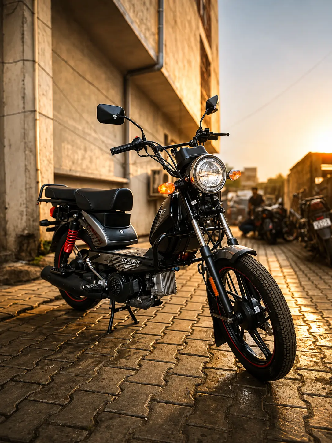 TVS XL100 Heavy Duty Alloy 2026 parked on a village road showing new 16 inch alloy wheels